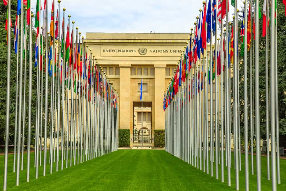Geneva, Switzerland -  Row of flags at entrance of United Nations Offices or Palais des Nations in Ariana Park, on shore of Lake Geneva. Since 1966 is main European headquarters of UN.