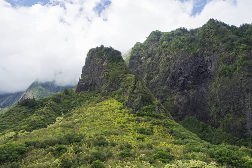 mountainous and lush iao valley state park amidst clouds in west maui hawaii