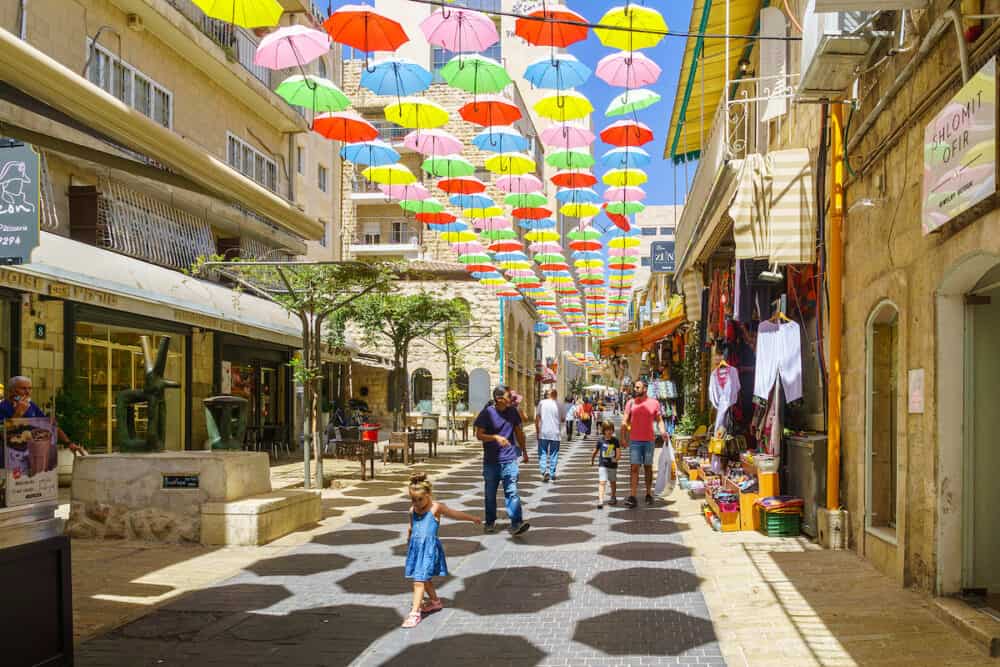 Jerusalem, Israel - Pedestrians and colorful umbrellas (parasols), in Yoel Moshe Solomon Street, the historic Nachalat Shiva neighborhood, the picturesque center of Jerusalem, Israel
