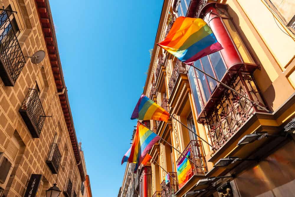 Balconies of the Chueca neighborhood of Madrid adorned with colors of the lgtb rainbow flag