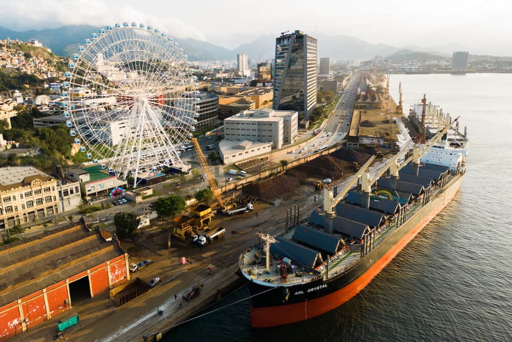 Rio de Janeiro, Brazil - Aerial view of Yup Star (Rio Star) ferris wheel and large industrial cargo ship.