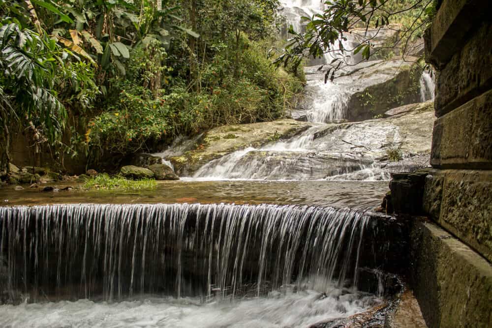 Rio de Janeiro, Brazil -  Beautiful waterfall called "Cascatinha Taunayon" on green nature in the Atlantic Rainforest, Tijuca Forest National Park