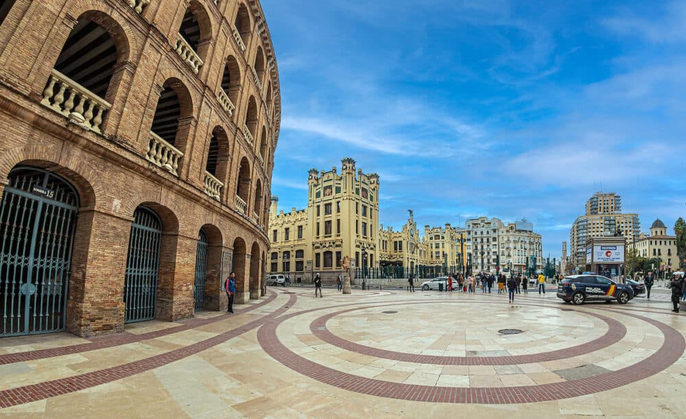 VALENCIA, SPAIN - View from Carrer d'Alacant of Facade of North station (Estacio del nord), building Plaza de toros and monument of Manuel Granero in Centro district of the city.