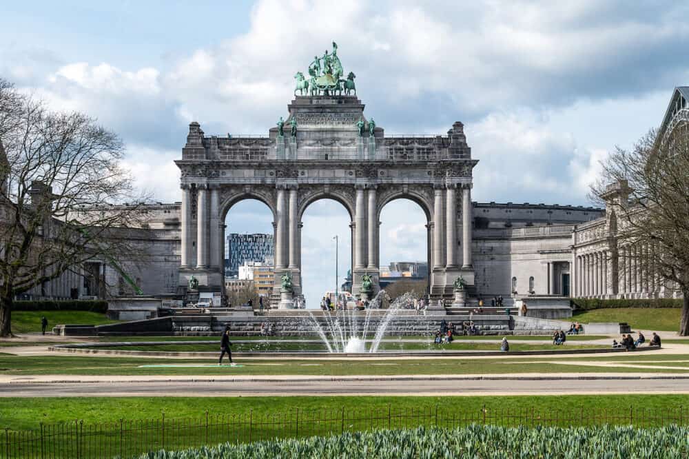 Brussels European Quarter, Belgium - The Triumphal arch at the Cinquentenaire park with green lawns and a fountain