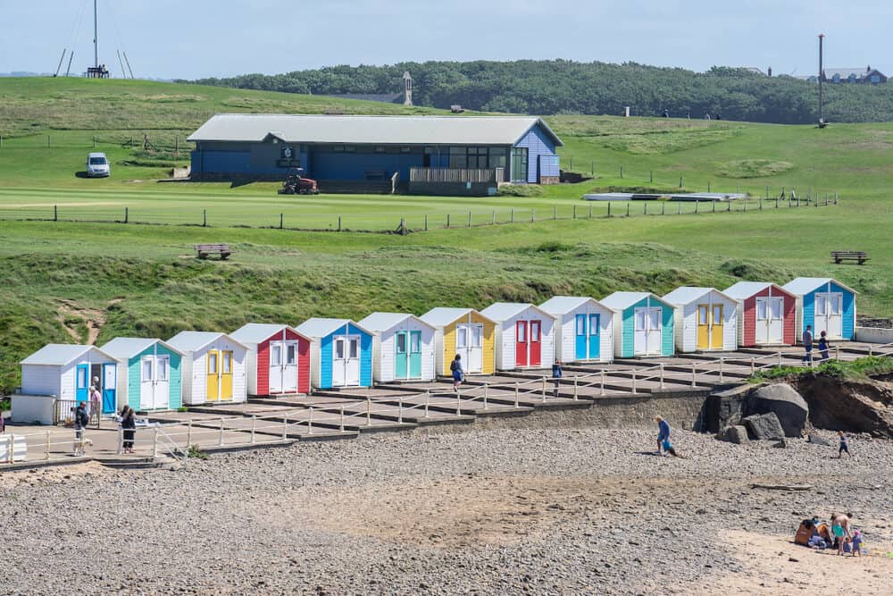 Multi coloured beach huts facing the beach at Bude Cornwall