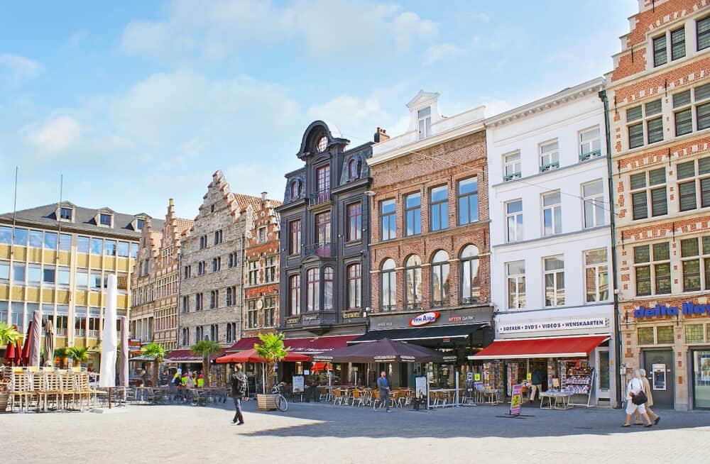GHENT BELGIUM -The row of pavement cafes and restaurants at the Korenmarkt Square offering tasty local cuisine and fresh beverages in cozy places in Ghent.