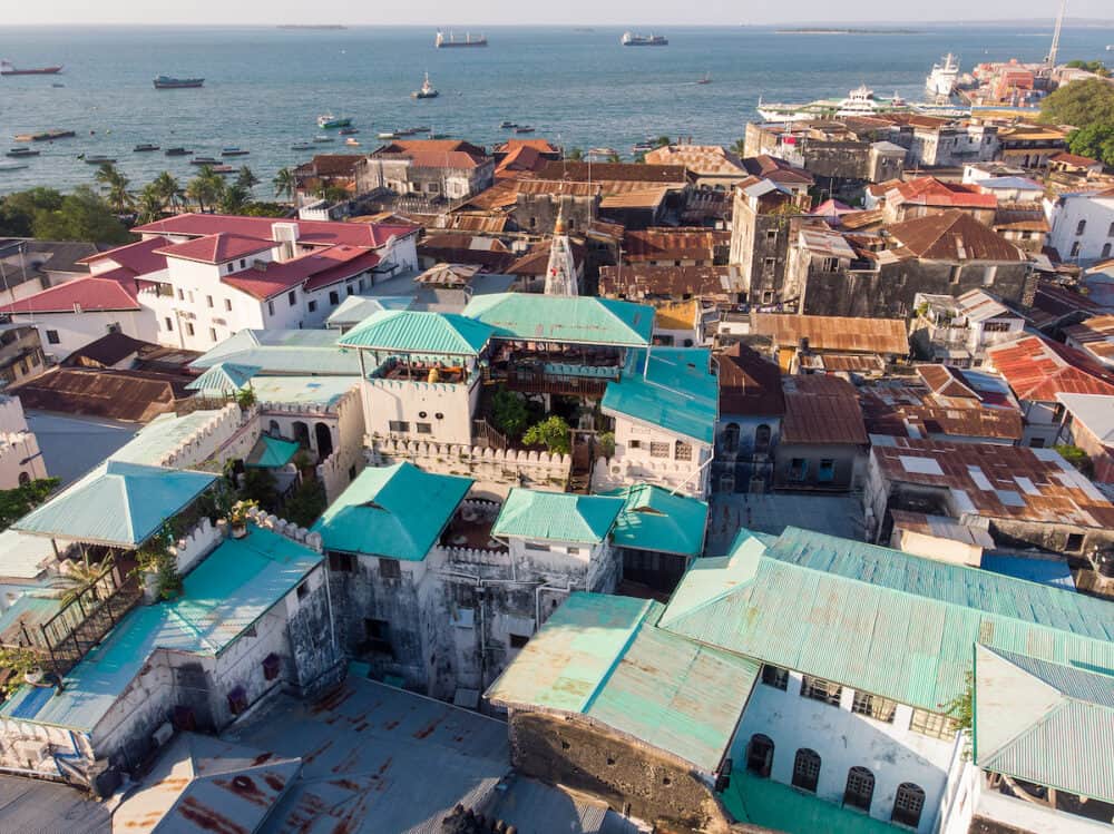 Above The Building Roofs Aerial View Of Zanzibar, Stone Town. Tanzania. Sunset Time Coastal City 