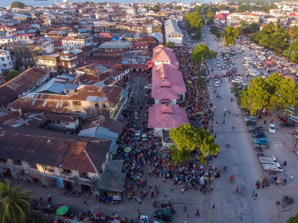 Aerial Shot of Crowded City Market in Stone Town, the Capital of Zanzibar, Tanzania. Active Trade on a Market at evening