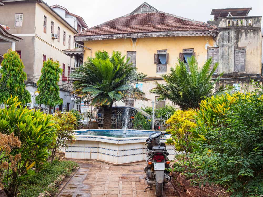 STONE TOWN, ZANZIBAR -Historic buildings surround courtyard and water fountain in center of  Stone Town, Zanzibar 