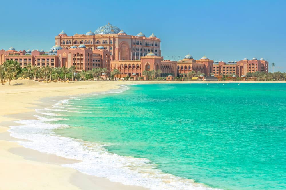 The beautiful private white beach belonging to Emirates Palace Hotel, a luxurious 7 star hotel with its own marina and helipad. Summer holidays concept. Luxury and comfort lifestyle.