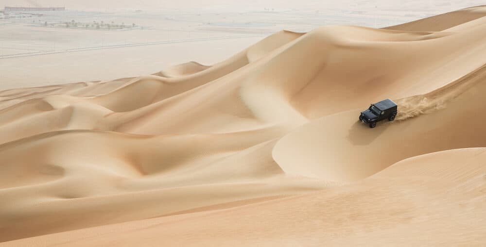 car driving in Rub al Khali Desert at the Empty Quarter in Abu Dhabi United Arab Emirates