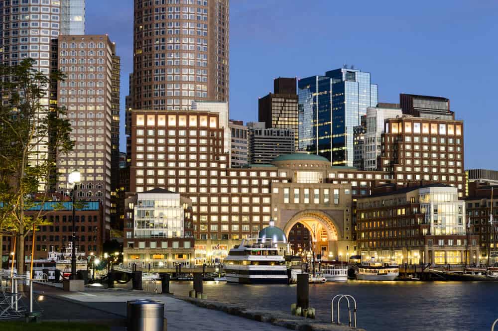 Boston Massachusetts USA - View from Fan Pier of Rowes Wharf lit by sun rising over Boston harbor
