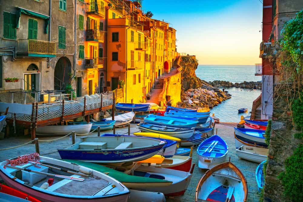 Riomaggiore village street boats and sea in Five lands on sunset Cinque Terre National Park Liguria Italy Europe.