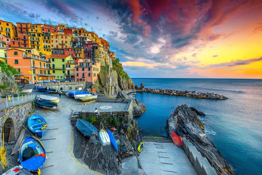 Admirable travel destination, wonderful mediterranean village with traditional colorful old houses and fishing boats at sunset, Manarola, Cinque Terre, Liguria, Italy, Europe