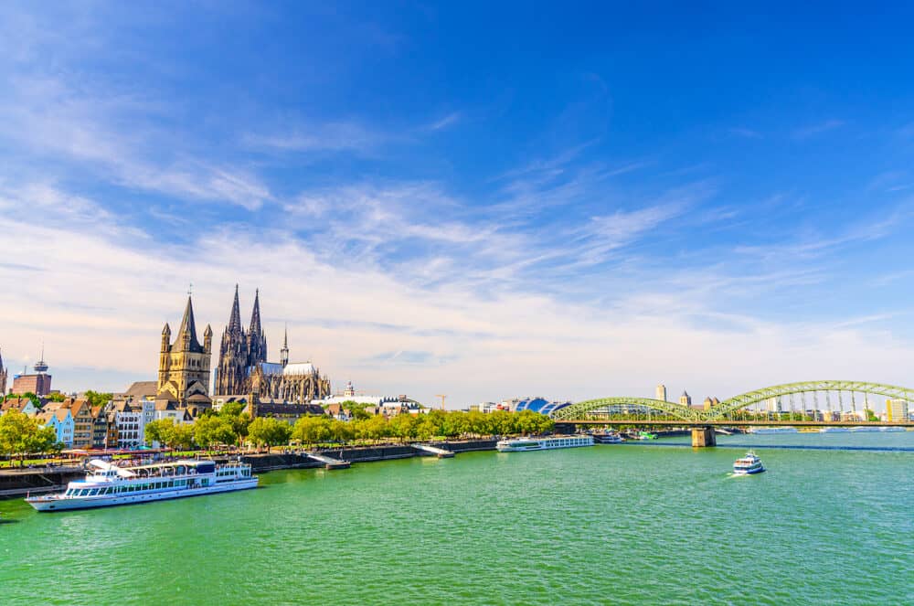 Cologne cityscape of historical city centre with Cologne Cathedral and Great Saint Martin Roman Catholic Church buildings, Hohenzollern Bridge across Rhine river, North Rhine-Westphalia, Germany