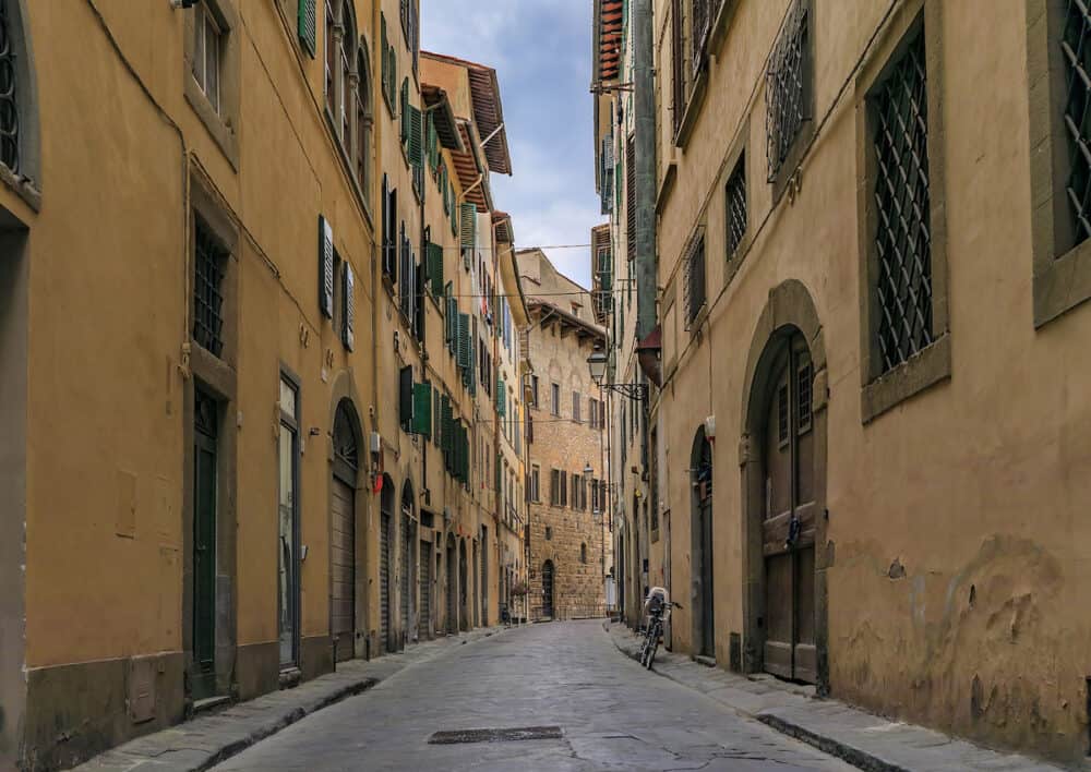Medieval Renaissance gothic buildings along a narrow street in Oltrarno Santo Spirito area of Centro Storico or Historic Centre of Florence, Italy