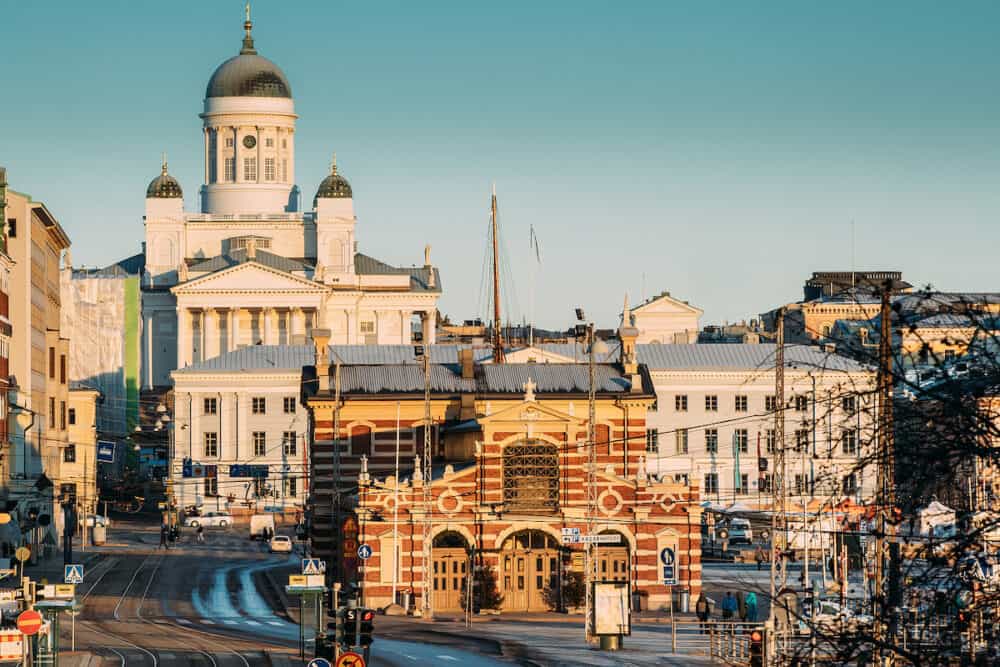 Helsinki, Finland. View Of Helsinki Cathedral And Old Market Hall Vanha Kauppahalli In Sunny Winter Day. Famous Dome Landmark In Neoclassical Style.