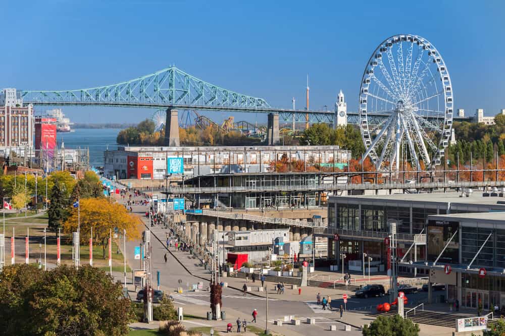 Montreal, CA -Aerial view of the Old Port of Montreal, with Obsevation Wheel, Jacques Cartier Bridge and Bonsecours Market