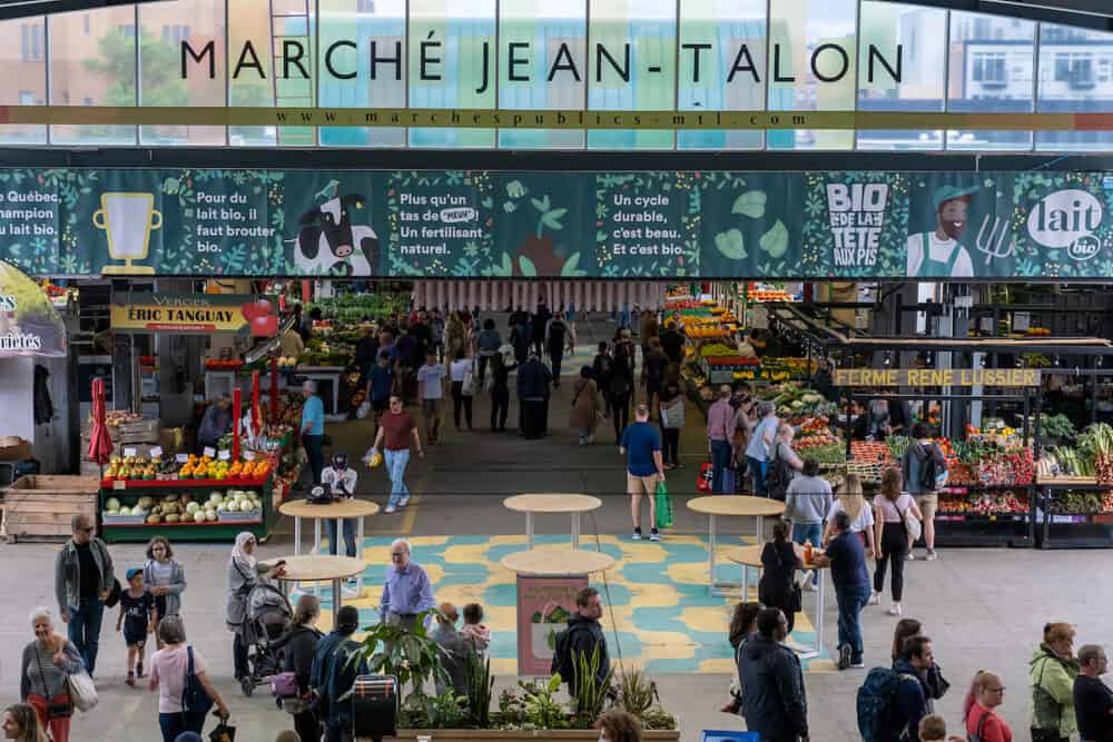 Montreal, CA - People buy groceries at Jean-Talon Market, the largest outdoor public market in North America.