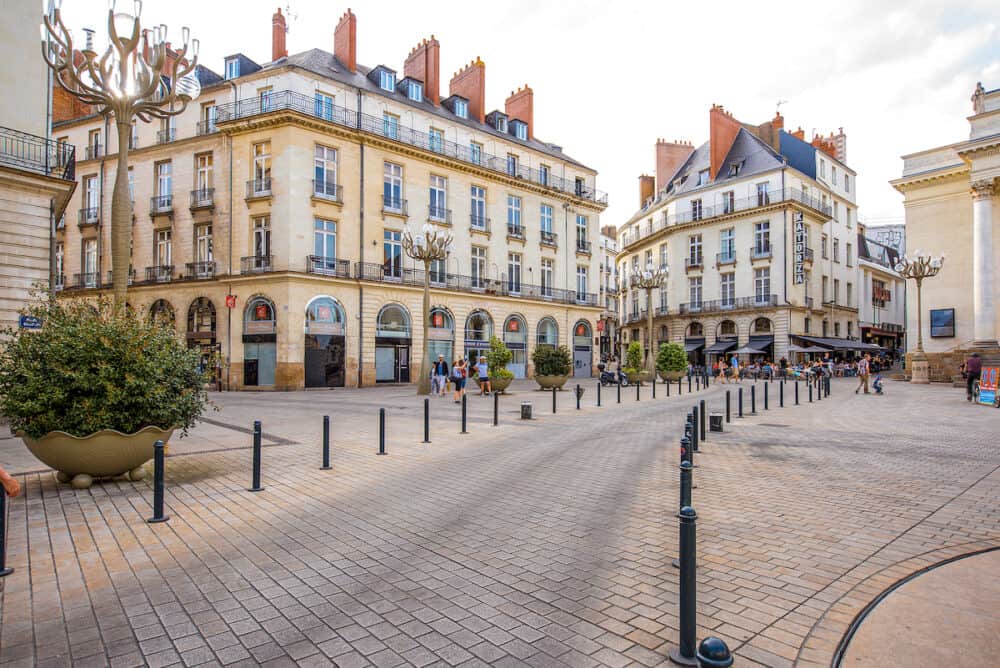 NANTES, FRANCE - View on the crowded with tourists Graslin square with beautiful buildings in Nantes city in France