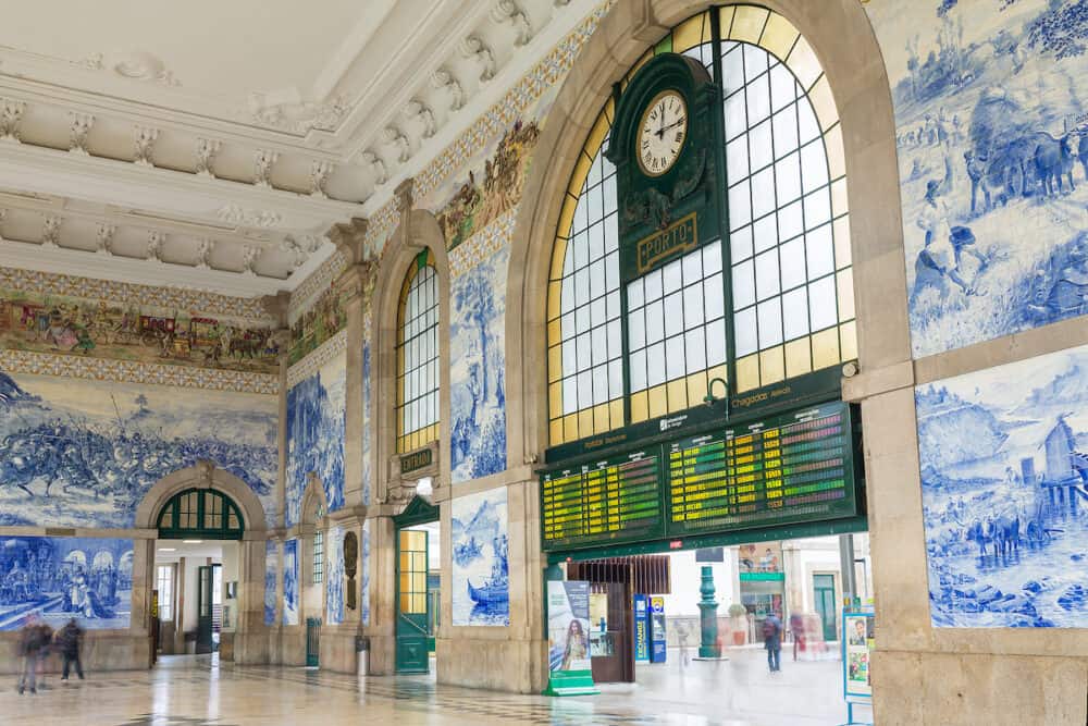 Porto, Portugal - People in the vestibule of Sao Bento Railway Station. It is decorated with approximately 20,000 azulejo tiles, dating from 1905-1916