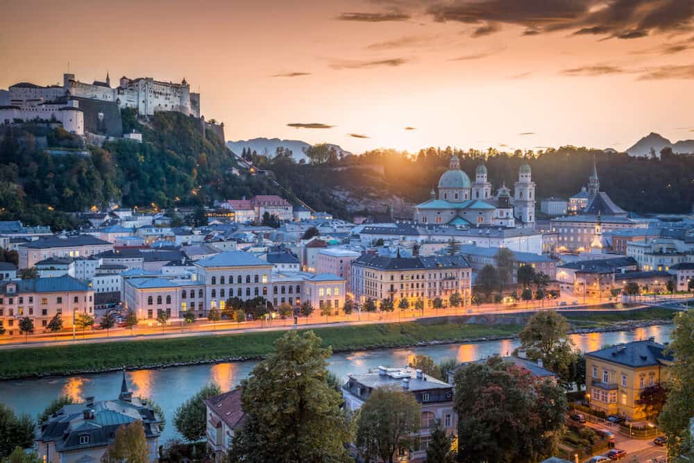 Aerial panoramic view of the historic city of Salzburg with Hohensalzburg Fortress in beautiful golden evening light at dusk in summer Salzburger Land Austria