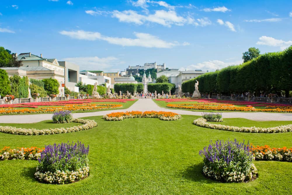 Beautiful view of famous Mirabell Gardens with the old historic Fortress Hohensalzburg in the background in Salzburg Austria