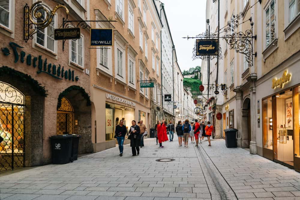 Salzburg, Austria - Getreidegasse. Scenic cityscape of historical city centre of Salzburg with a crowd of people walking