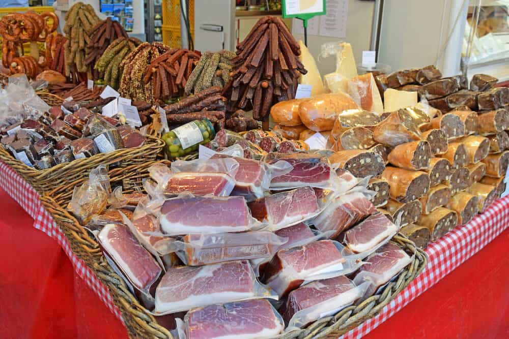 Salzburg, Austria -all kinds of meat products at a stand at street food open market - Salzburger Brezen in Salzburg
