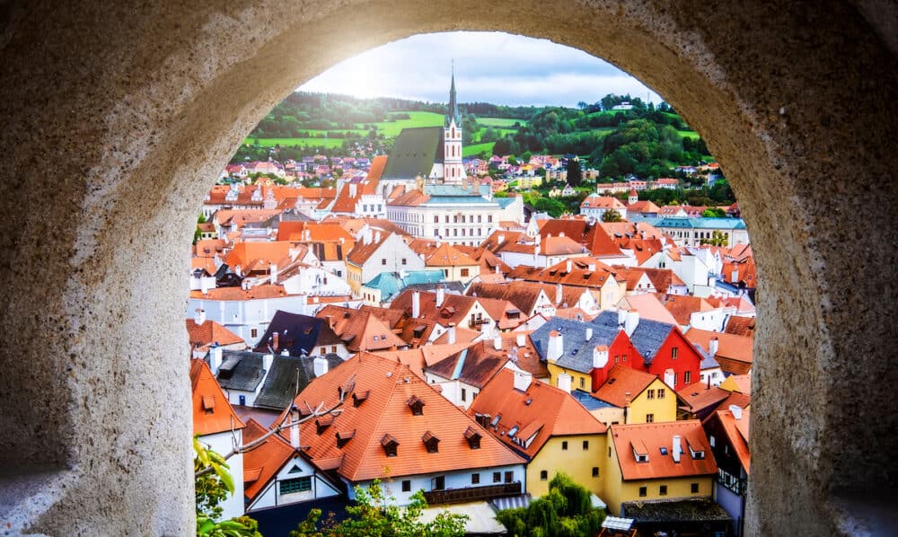 Beautiful top view of Cesky Krumlov cityscape though stone ancient arch