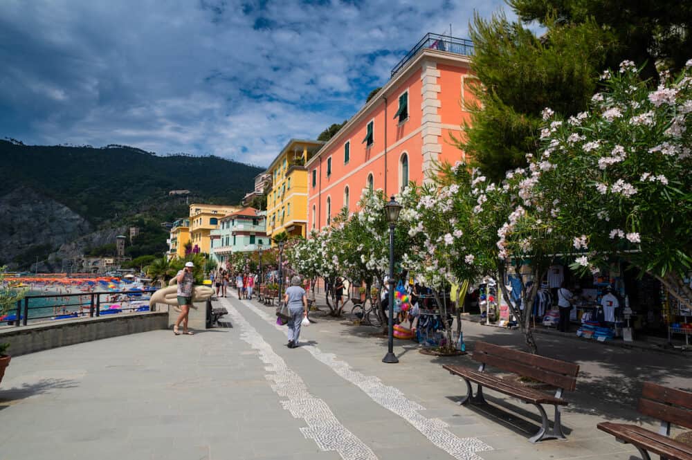 Monterosso, Liguria, Italy.  The promenade offers a pleasant view of the beaches with the bathing establishments and the surrounding nature. Beautiful summer day