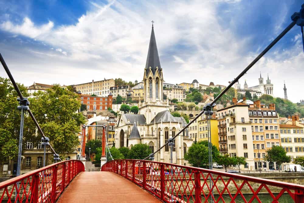 Pedestrian Saint Georges footbridge and the Saint Georges church in Lyon, France