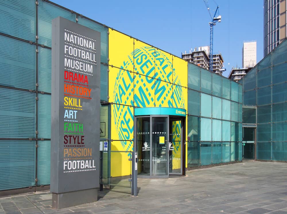 manchester, united kingdom - signs around the front entrance of the national football museum in manchester city centre