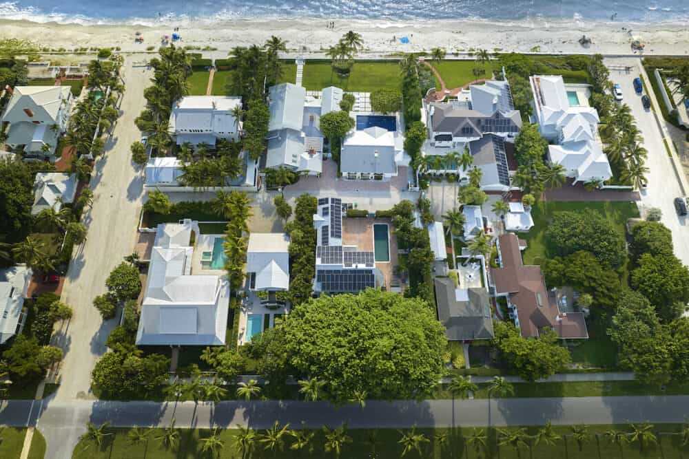 View from above of large residential houses in closed living golf club in south Florida. American dream homes as example of real estate development in US suburbs.