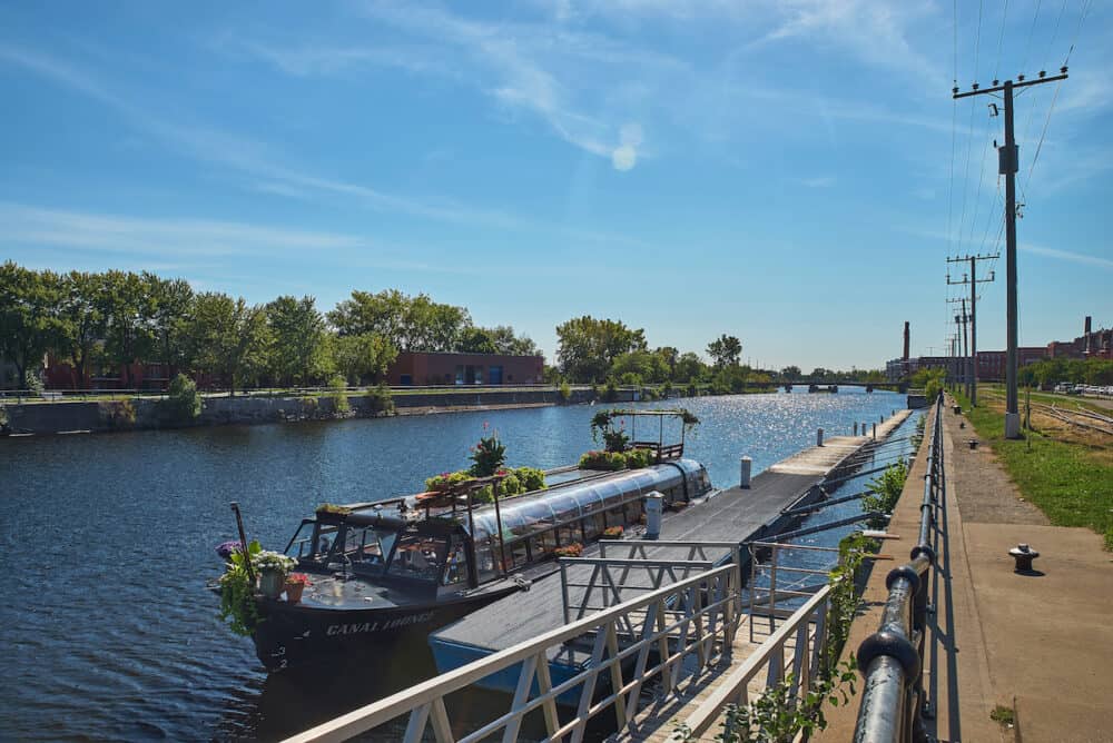 MONTREAL, CANADA - Canal de Lachine on a sunny day. Pleasure boat at the pier.