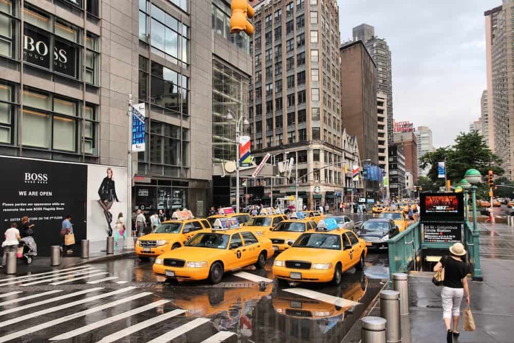 People ride yellow taxi cabs along 8th Avenue in New York. As of 2012 there were 13,237 yellow taxi cabs registered in New York City.