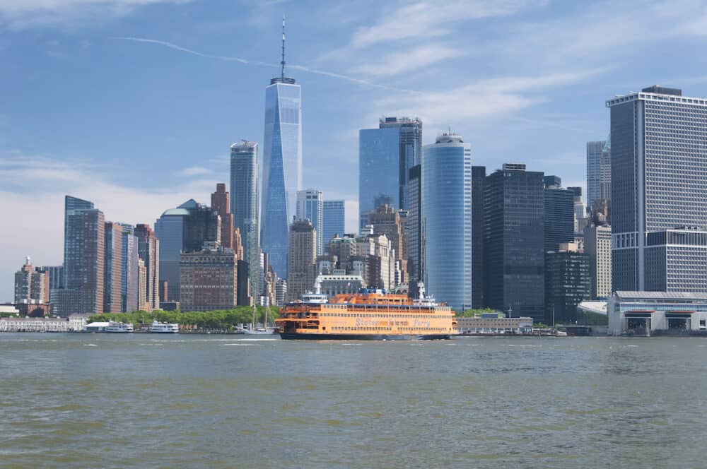 New york city, new york. the staten island ferry on the hudson river in lower manhattan in new york city on a sunny day.