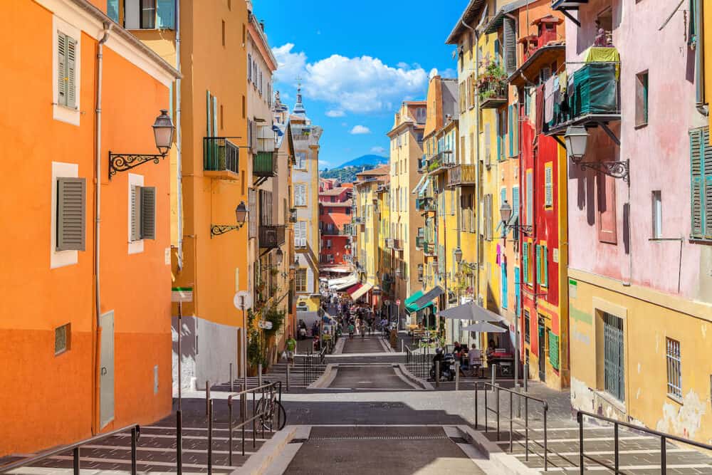 NICE, FRANCE - Narrow street in old tourist part of Nice - fifth most populous city and one of the most visited cities in France, receiving 4 million tourists every year.