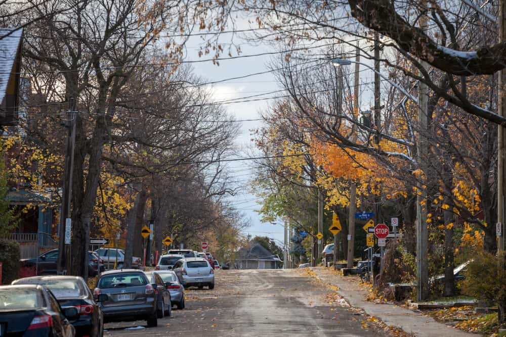 OTTAWA, CANADA - Typical north American residential street in autumn in Centretown, Ottawa, Ontario, during an autumn afternoon, with cars parked