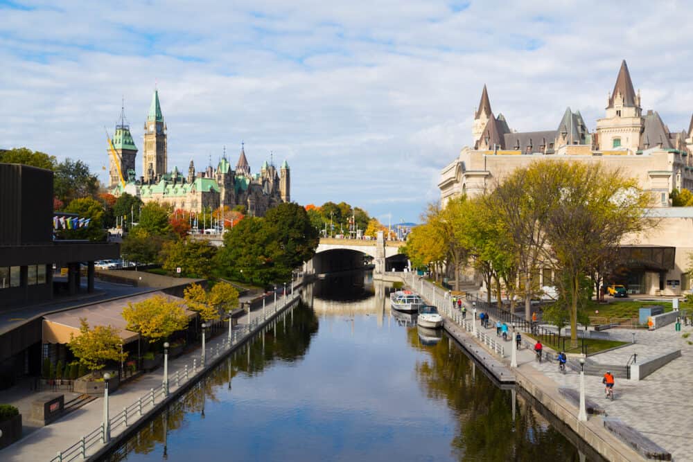 OTTAWA CANADA - A view up the rideau Canal towards the Ottawa Parliament. Cyclists can be seen along the Canal
