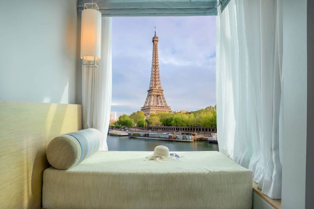 Summer Travel Vacation and Holiday concept - Beautiful Eiffel tower view at window in resort near Seine river Paris France