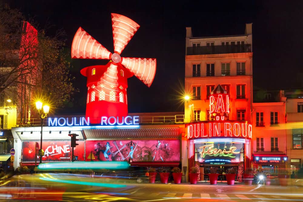 Paris, France - The picturesque famous cabaret Moulin Rouge located close to Montmartre in the Paris red-light district of Pigalle on boulevard Clichy at night, Paris, France
