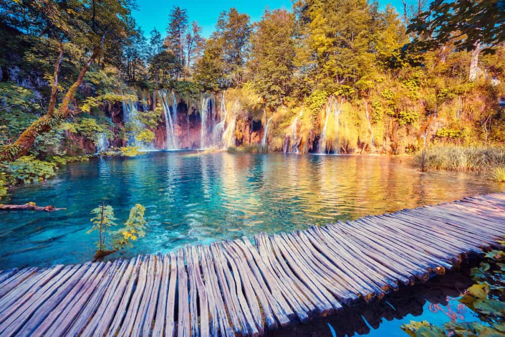 Majestic view on turquoise water and sunny beams in the Plitvice Lakes National Park. Croatia. Europe. Dramatic unusual scene. Beauty world. Retro filter and vintage style. Instagram toning effect.