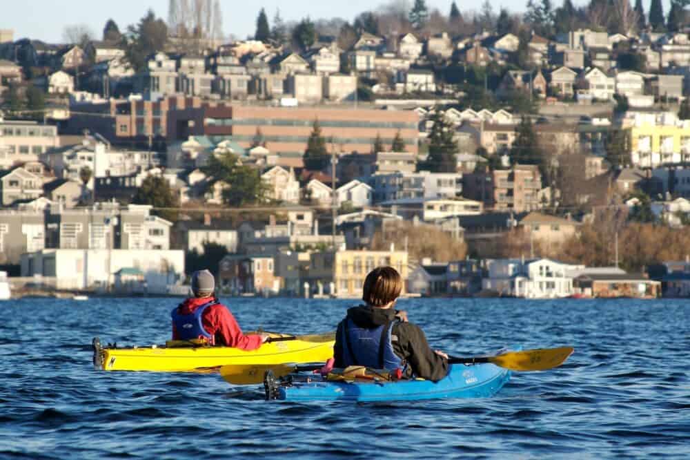 Two friends enjoying a kayaking session on Lake Union in Seattle.