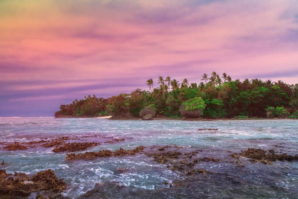 Tropical island on the dawn. Landscape hill, clouds and mountains rocks with rainforest. Tropical island, sea bay and lagoon, Siargao. Azure water of lagoon. Shore Landscape Bay. Travel concept