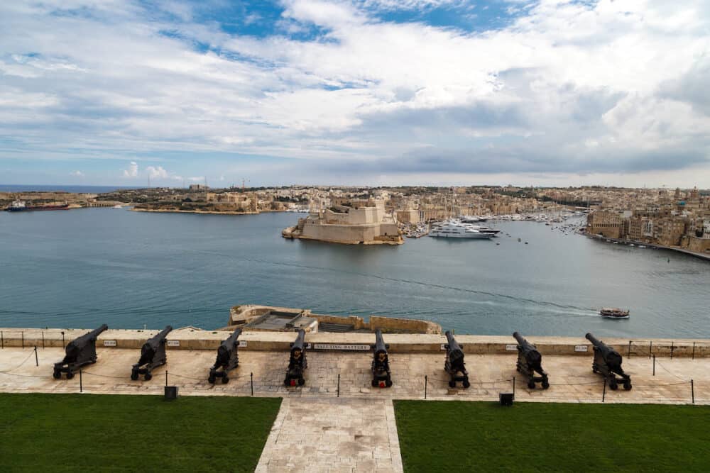 VALLETTA MALTA - View of the gardens of Lascaris War Rooms in Valletta Malta with seascape on cloudy blue sky background.