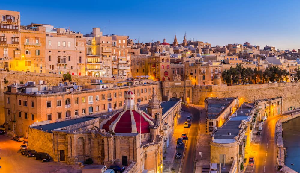 Valletta Malta - The traditional houses and walls of Valletta the capital city of Malta on an early summer morning before sunrise with clear blue sky