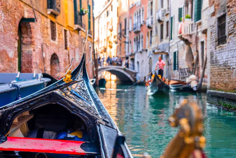 Riding a traditional gondola down the narrow canals in Venice, Italy.