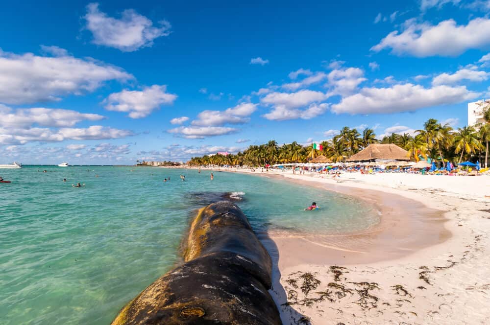 ISLA MUJERES, MEXICO - : tourists enjoy tropical sea on famous Playa del Norte beach in Isla Mujeres, Mexico. The island is located 8 miles northeast of Cancún in the Caribbean Sea.