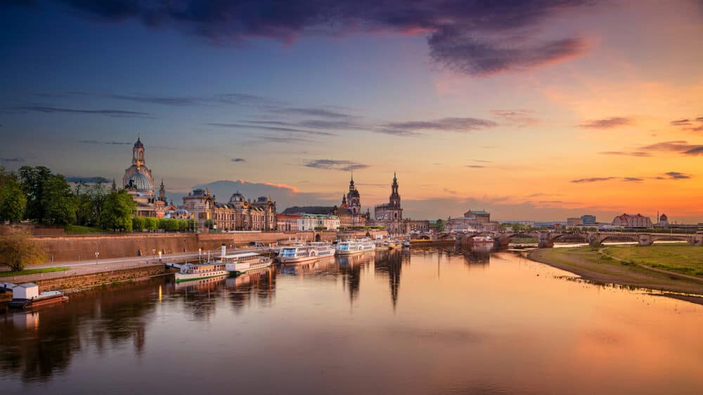 Dresden, Germany. Panoramic  cityscape image of Dresden, Germany with reflection of the city in the Elbe river, during sunset.
